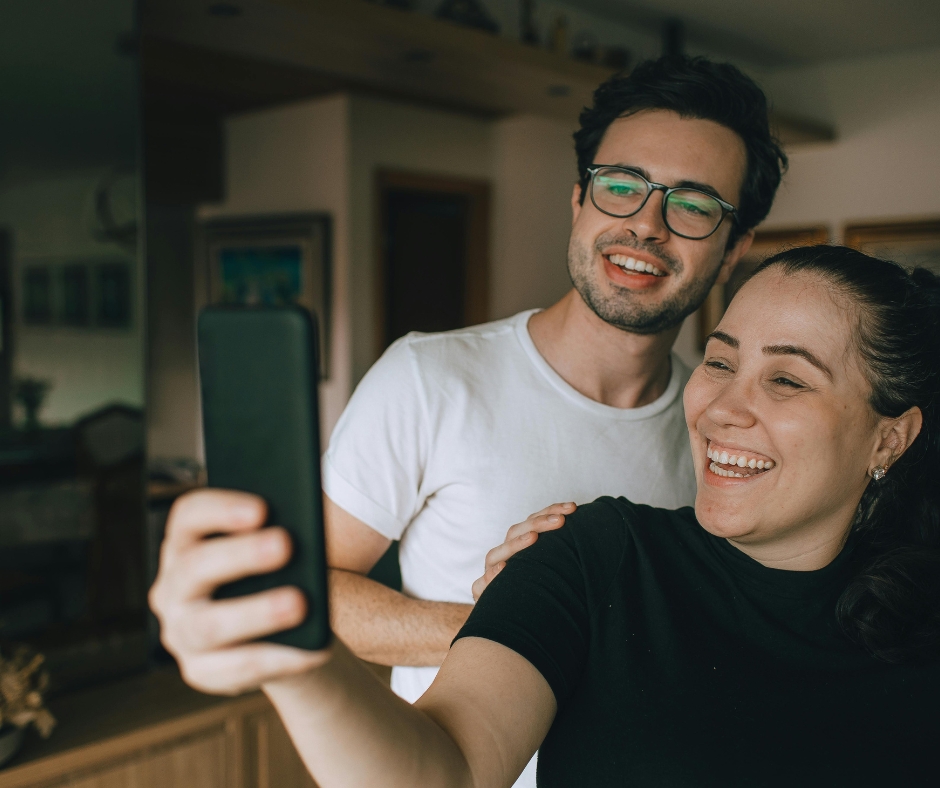 Couple attending virtual therapy session together on a phone from home