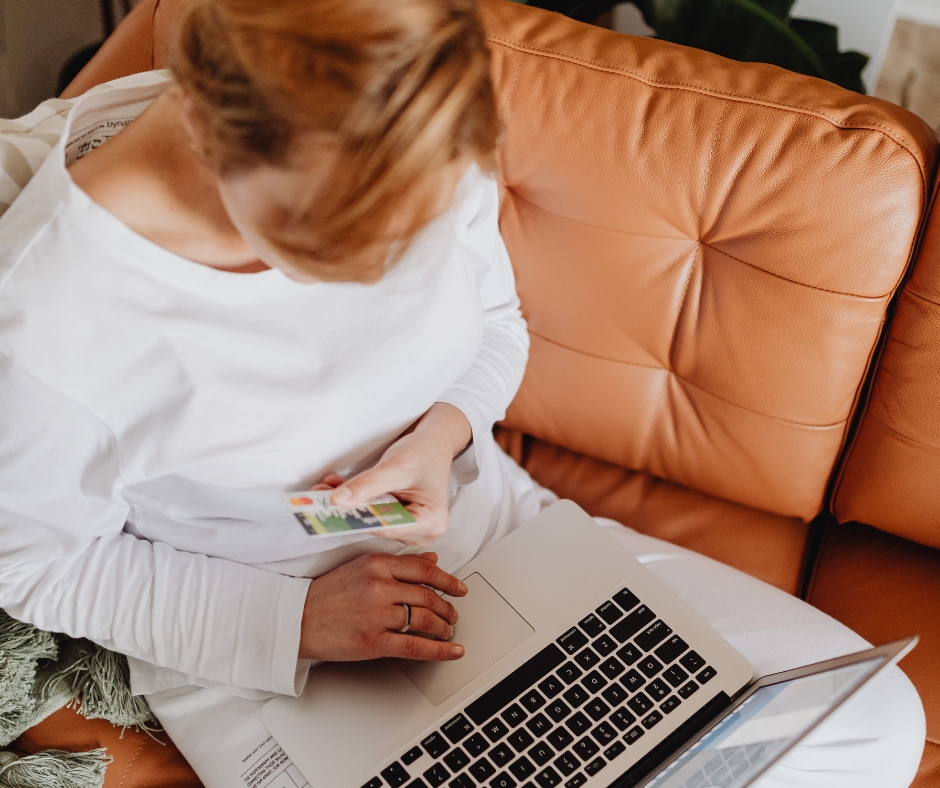 Woman entering credit card information on a laptop while researching therapy costs online