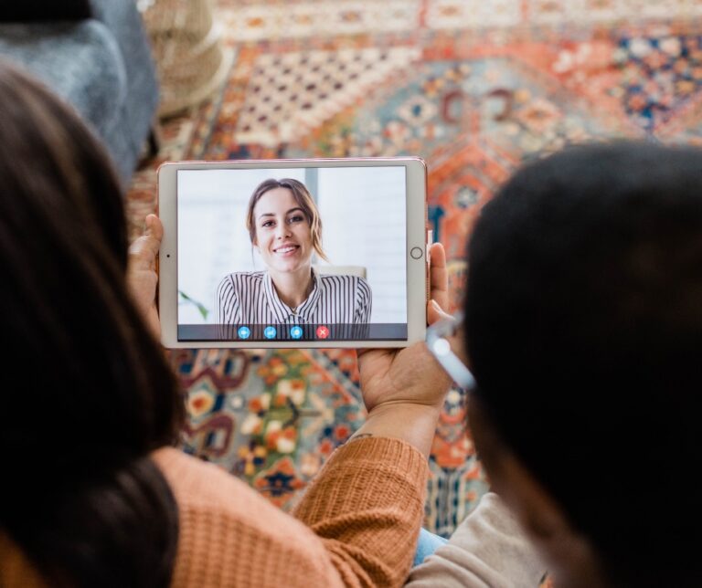 People speaking with a therapist during an online video therapy session