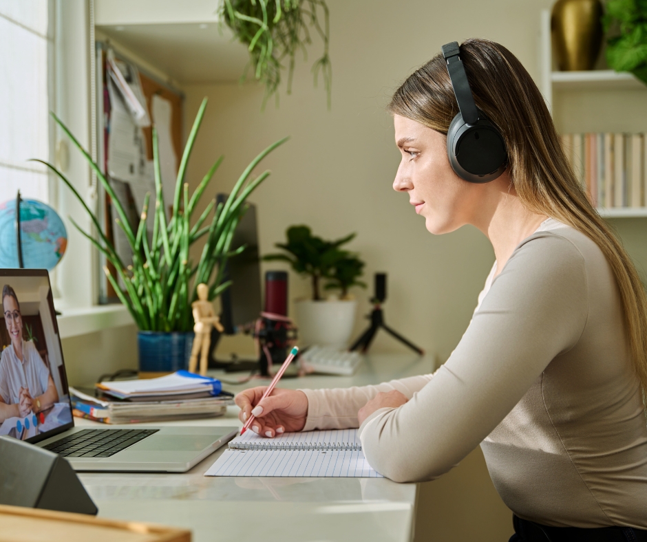 Woman attending an online therapy session from home on a laptop