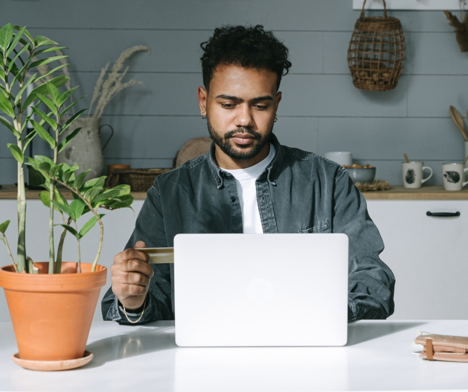 Man signing up for online therapy on a laptop at home