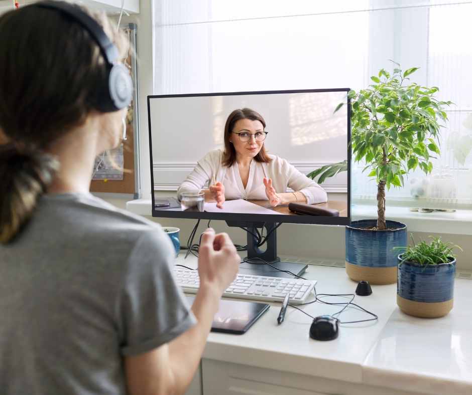 woman attending an online therapy session on her laptop