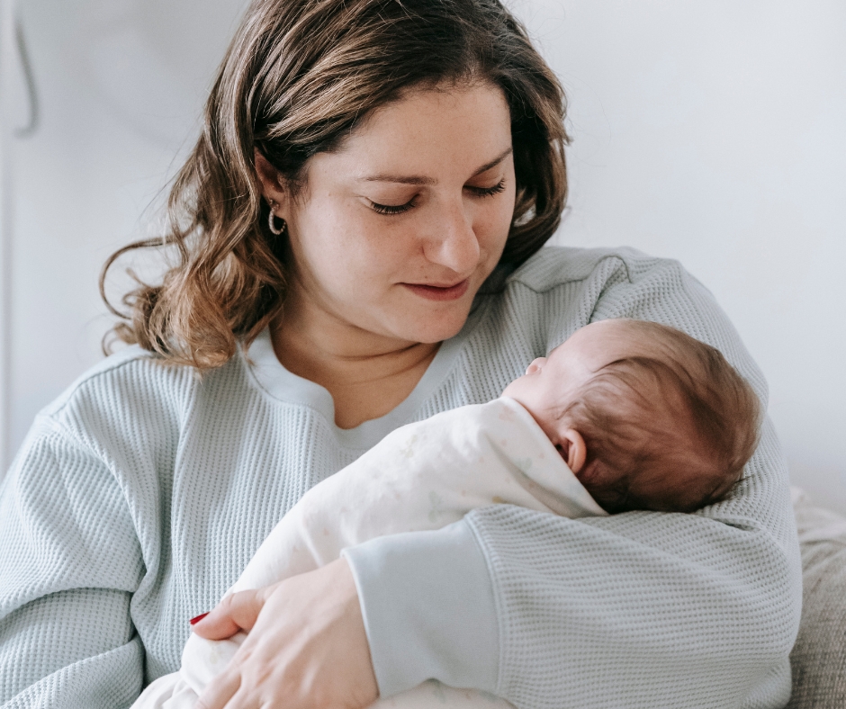 Mother holding her newborn baby while sharing a quiet bonding moment