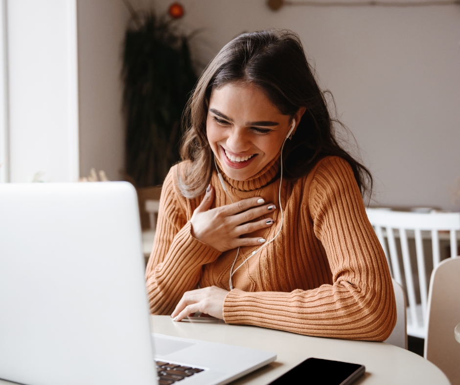Mother participating in an online therapy session from home on her laptop