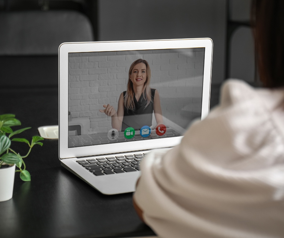 Person participating in an online therapy session from home using a laptop