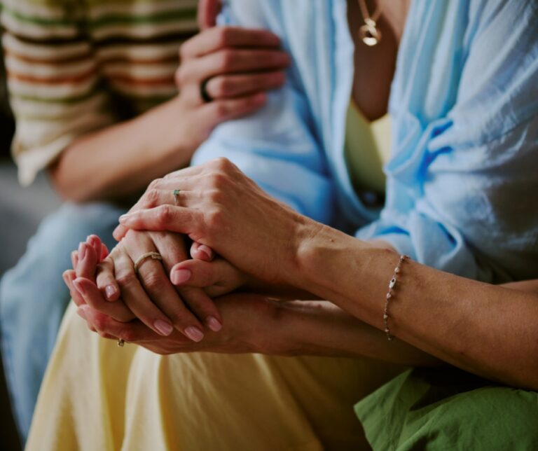 Adult daughter comforting and supporting her mother during an emotional conversation at home