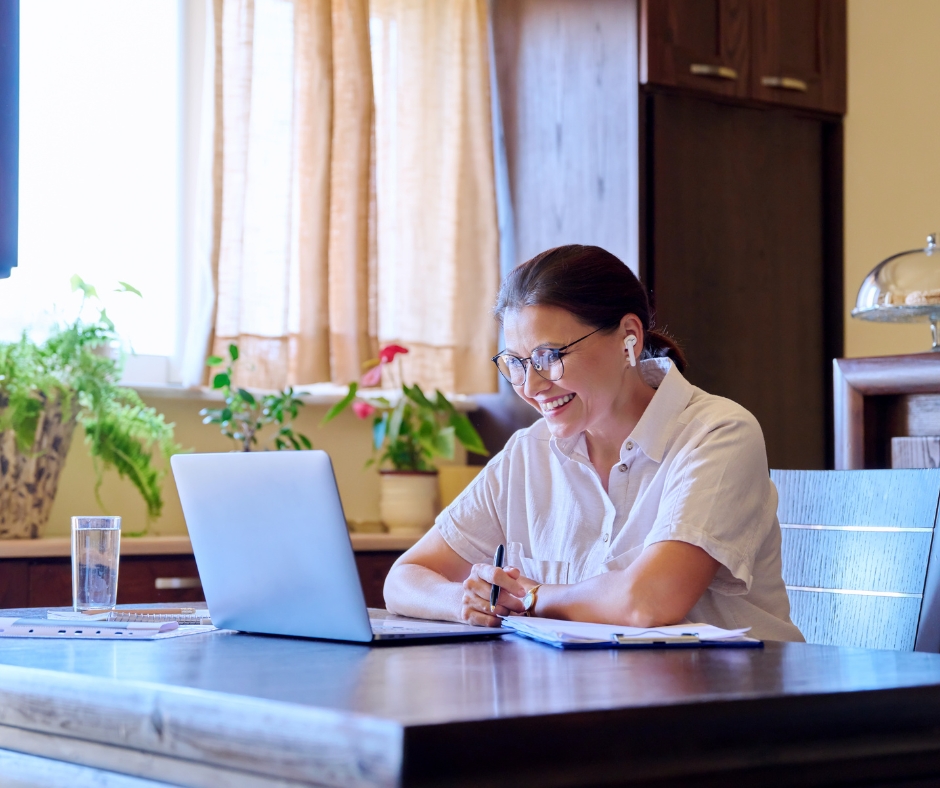 Woman participating in an online therapy session from home using a laptop