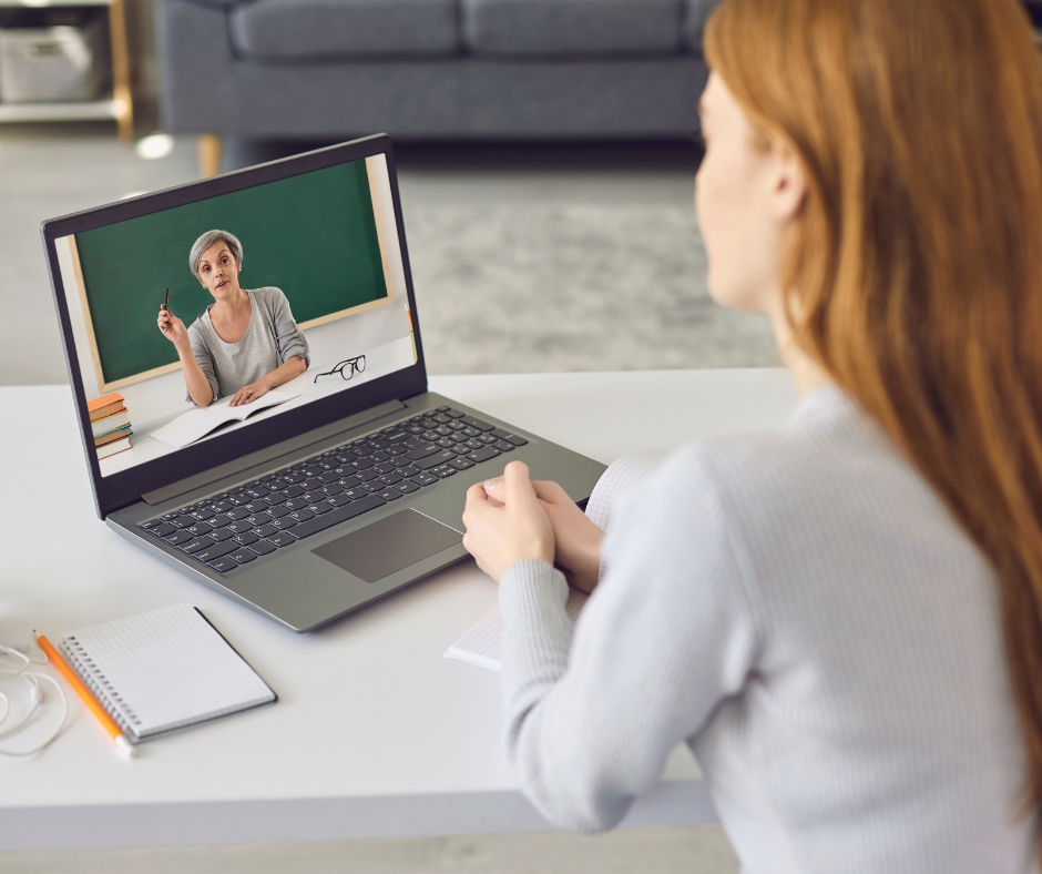 Woman participating in an online therapy session from home using a laptop while speaking with a licensed therapist