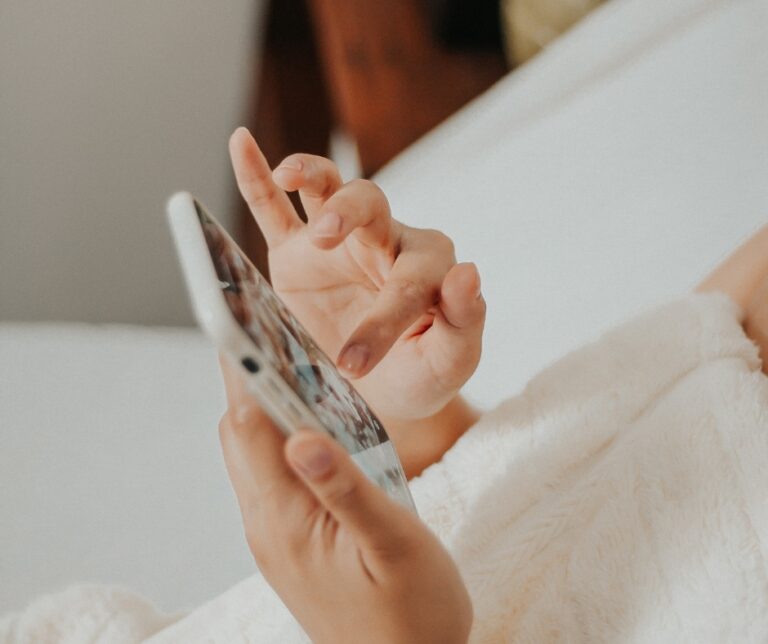 Person looking at a smartphone while scrolling through social media