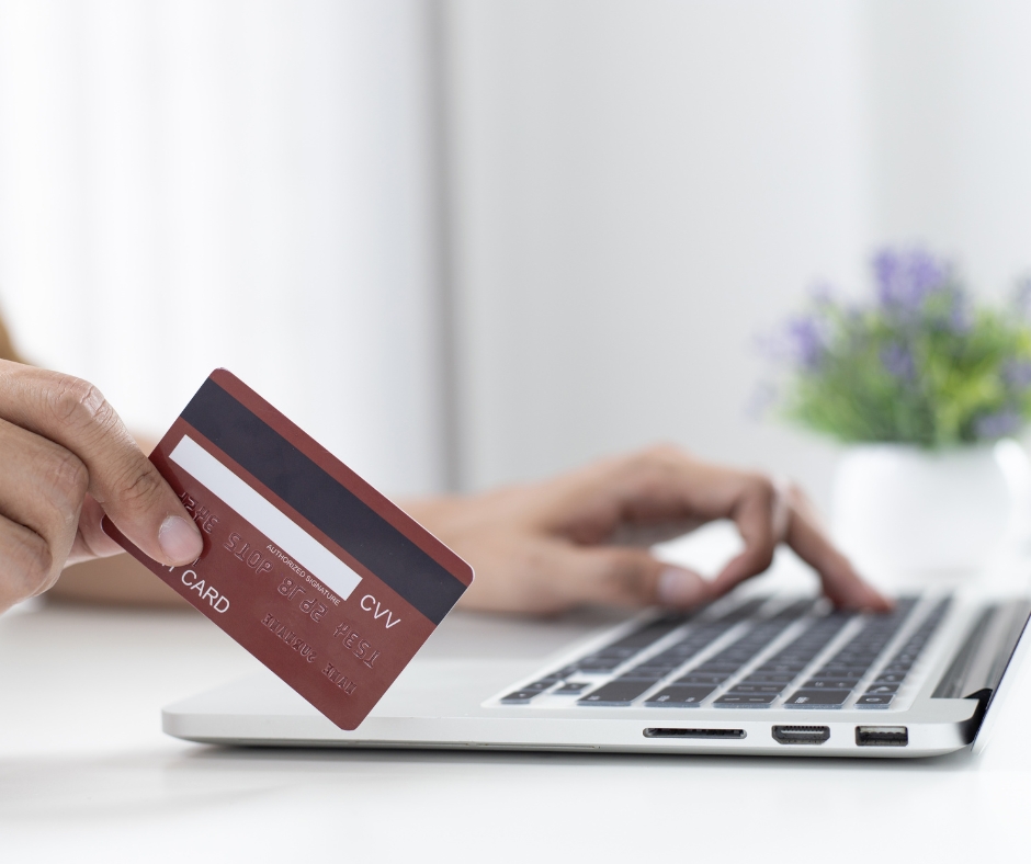 Person making an online payment for a therapy session using a laptop and credit card