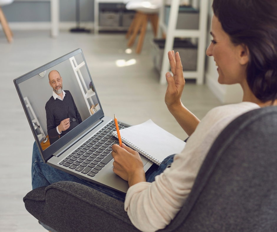 Woman participating in a private online therapy session from home using a laptop