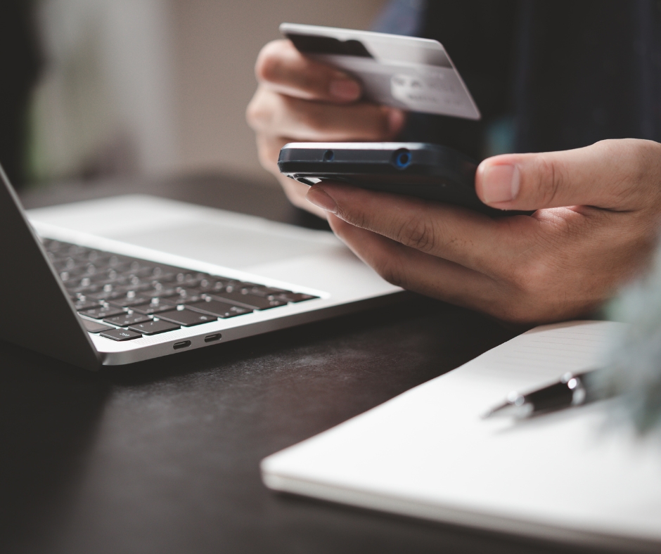 Person paying for an online therapy session using a laptop and credit card from home
Image Title: