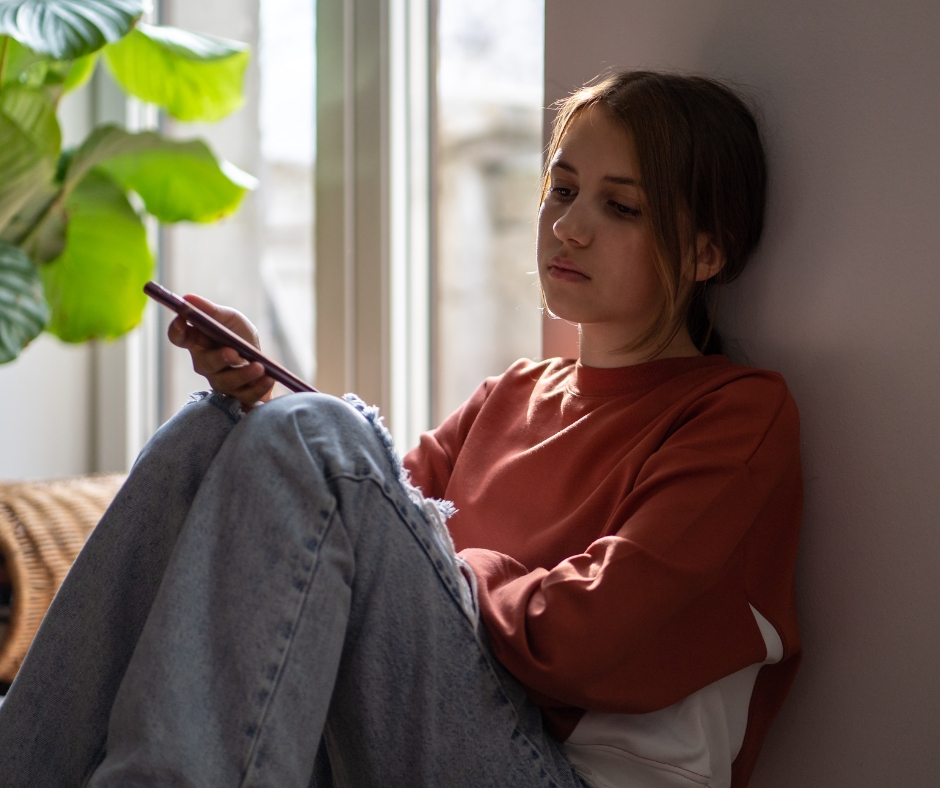 Woman sitting alone with a sad expression, reflecting feelings of depression and emotional distress