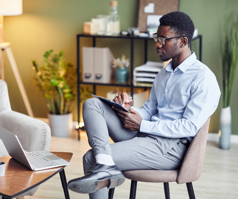 Man participating in an online therapy session with a therapist from home